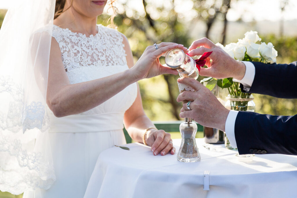 couple pour sand in sand ceremony at wedding marry in cork