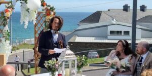 Reading at wedding ceremony Dunmore House Hotel overlooking water ideal wedding reading