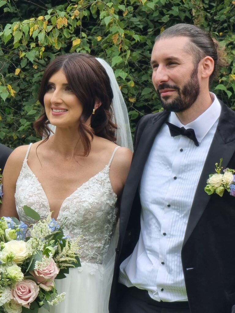 Bride and groom smiling while signing the wedding register at Fernhill House, Clonakilty.