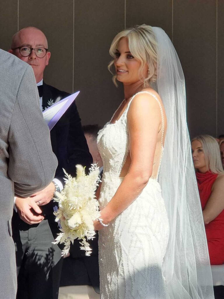 Radiant bride in an elegant white wedding gown exchanging vows at Fota Island Resort, Cork.