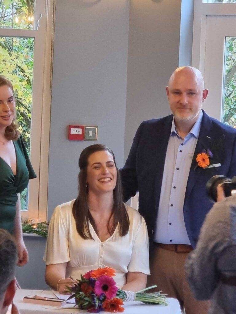 Bride and groom signing the wedding register during an intimate ceremony at Seaview House, Ballylickey, Co Cork.