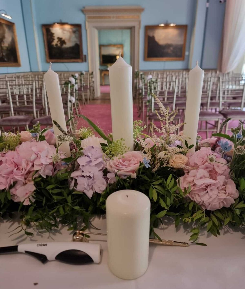 Unity candle ceremony setup with floral decorations at Fota House wedding venue.